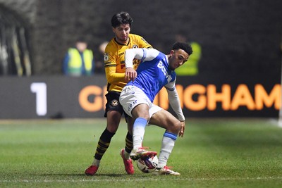 040325 - Newport County v Gillingham - Sky Bet League 2 - Anthony Glennon of Newport County is challenged by Remeao Hutton of Gillingham