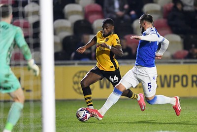 040325 - Newport County v Gillingham - Sky Bet League 2 - David Ajiboye of Newport County is challenged by Max Ehmer of Gillingham