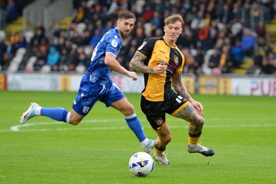 200925 - Newport County v Gillingham - Sky Bet League 2 - Kai Whitmore of Newport County is challenged by Josh Andrews of Gillingham