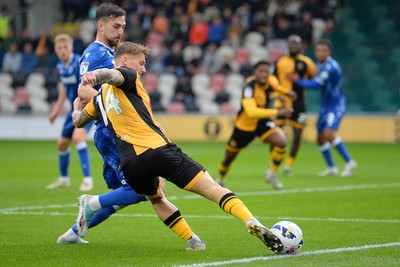 200925 - Newport County v Gillingham - Sky Bet League 2 - Kai Whitmore of Newport County is challenged by Josh Andrews of Gillingham