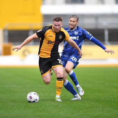200925 - Newport County v Gillingham - Sky Bet League 2 - Lee Jenkins of Newport County is challenged by Elliott Nevitt of Gillingham