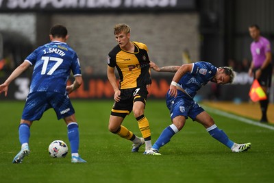 200925 - Newport County v Gillingham - Sky Bet League 2 - Tom Davies of Newport County is challenged by Jonny Smith of Gillingham