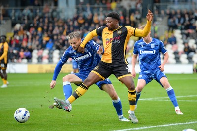 200925 - Newport County v Gillingham - Sky Bet League 2 - Bobby Kamwa of Newport County is challenged by Elliott Nevitt of Gillingham