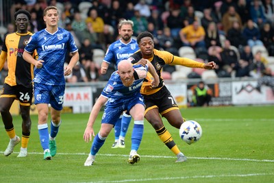 200925 - Newport County v Gillingham - Sky Bet League 2 - Bobby Kamwa of Newport County is challenged by Jonathan Williams of Gillingham