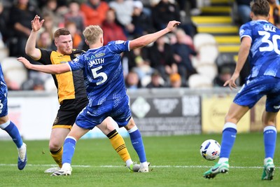 200925 - Newport County v Gillingham - Sky Bet League 2 - Lee Jenkins of Newport County is challenged by Andy Smith of Gillingham