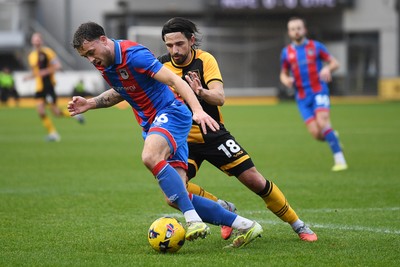 070226 - Newport County v Grimsby Town - Sky Bet League 2 - Liam Shepard of Newport County is challenged by Reece Staunton of Grimsby