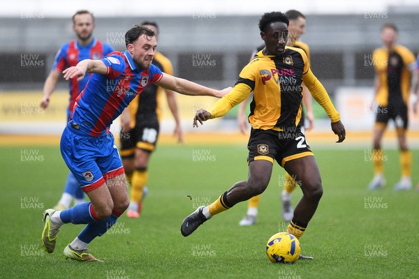 070226 - Newport County v Grimsby Town - Sky Bet League 2 - Nathan Opoku of Newport County is challenged by Reece Staunton of Grimsby