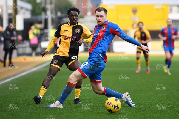 070226 - Newport County v Grimsby Town - Sky Bet League 2 - Nathan Opoku of Newport County is challenged by Cameron McJannet of Grimsby