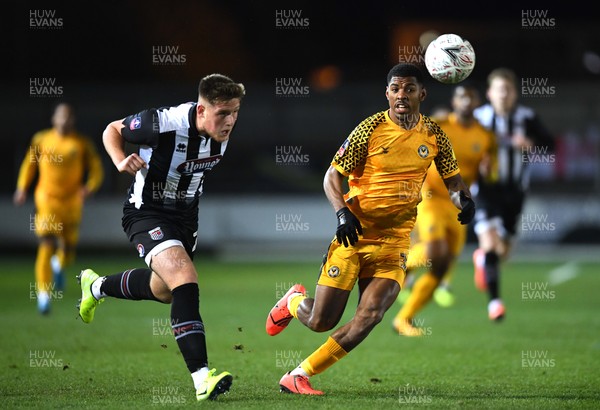 201119 - Newport County v Grimsby Town - FA Cup - Tristan Abrahams of Newport County competes with Mattie Pollock of Grimsby Town