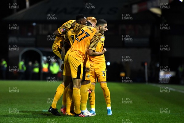 201119 - Newport County v Grimsby Town - FA Cup - Joss Labadie (hidden) of Newport County celebrates scoring goal with team mates