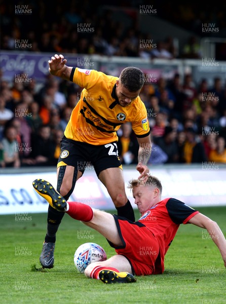 250818 - Newport County v Grimsby Town - SkyBet League 2 - Tyler Hornby-Forbes of Newport County is tackled by Luke Hendrie of Grimsby Town