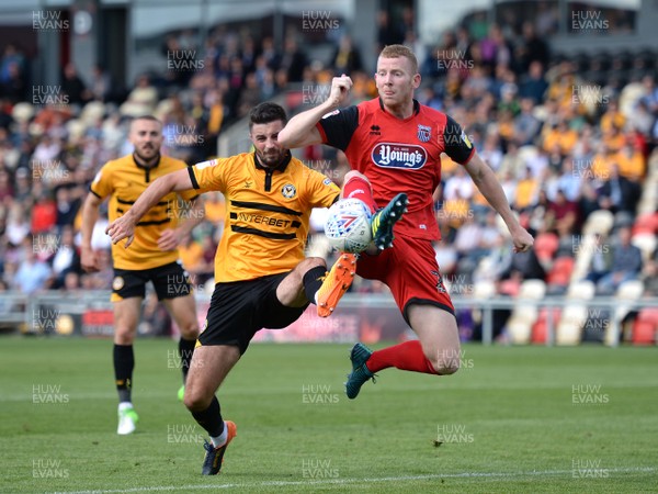 250818 - Newport County v Grimsby Town - SkyBet League 2 - Padraig Amond of Newport County and Alex Whitmore of Grimsby Town compete