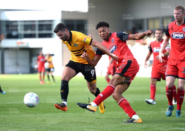 250818 - Newport County v Grimsby Town - SkyBet League 2 - Padraig Amond of Newport County is tackled by Akin Famewo of Grimsby Town
