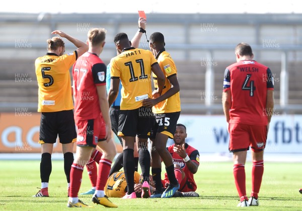 250818 - Newport County v Grimsby Town - SkyBet League 2 - Wes Thomas (ground) of Grimsby Town is shown a red card