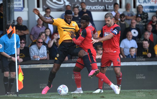 250818 - Newport County v Grimsby Town - SkyBet League 2 - Jamille Matt of Newport County is tackled by Mitch Rose of Grimsby Town