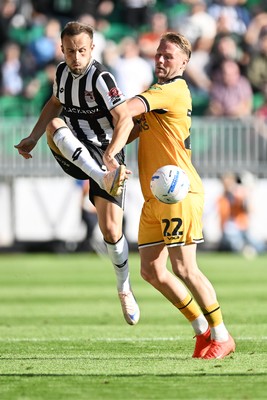 260926 - Newport County v Grimsby Town - Sky Bet League 2 - Cameron Norman of Newport County is challenged by Charles Vernam of Grimsby