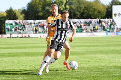 260926 - Newport County v Grimsby Town - Sky Bet League 2 - Cameron Norman of Newport County is challenged by Charles Vernam of Grimsby