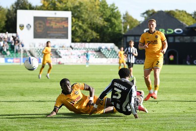 260926 - Newport County v Grimsby Town - Sky Bet League 2 - Michael Adu-Poku of Newport County is challenged by Jayden Sweeney of Grimsby