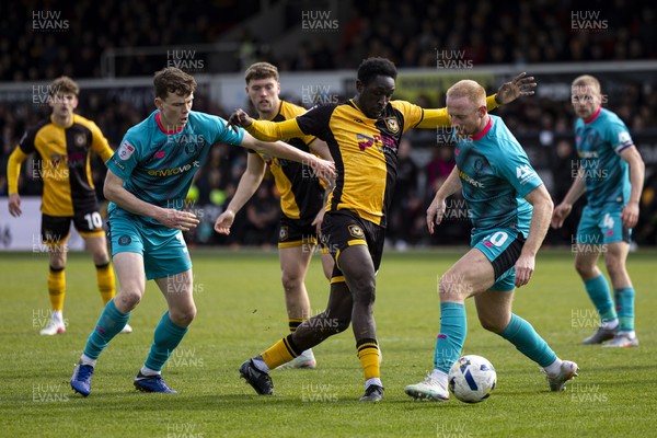 110426 - Newport County v Harrogate Town - Sky Bet League 2 - Nathan Opoku of Newport County in action against Liam Gibson of Harrogate Town