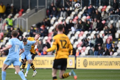 150325 - Newport County v Harrogate Town - Sky Bet League 2 - James Clarke of Newport County is challenged by Josh March of Harrogate Town