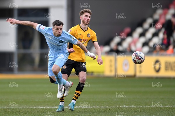 150325 - Newport County v Harrogate Town - Sky Bet League 2 - Matthew Baker of Newport County is challenged by Josh March of Harrogate Town