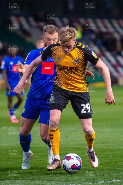 250423 - Newport County v Harrogate Town - Sky Bet League 2 - Will Evans of Newport County holds off George Thomson of Harrogate Town