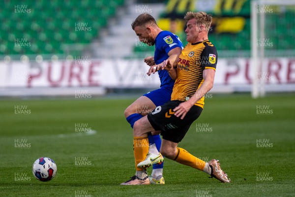 250423 - Newport County v Harrogate Town - Sky Bet League 2 - Will Evans of Newport County challenges George Thomson of Harrogate Town