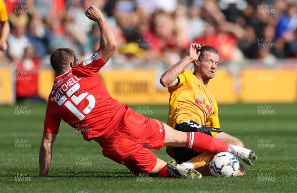 040921 - Newport County v Leyton Orient - SkyBet League Two - Alex Fisher of Newport County is tackled by Alex Mitchell of Leyton Orient