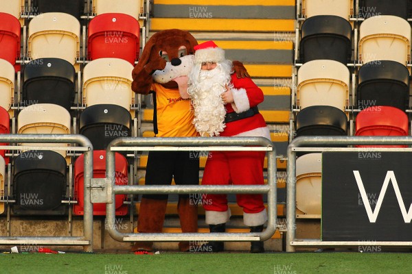 231217 - Newport County v Lincoln City - Sky Bet League 2 - Sbwty the Dog enjoys the game with Santa 