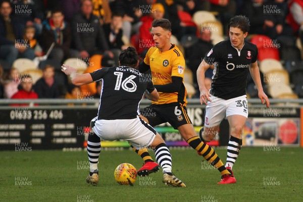 231217 - Newport County v Lincoln City - Sky Bet League 2 - Ben White of Newport County takes on Michael Bostwick of Lincoln City 