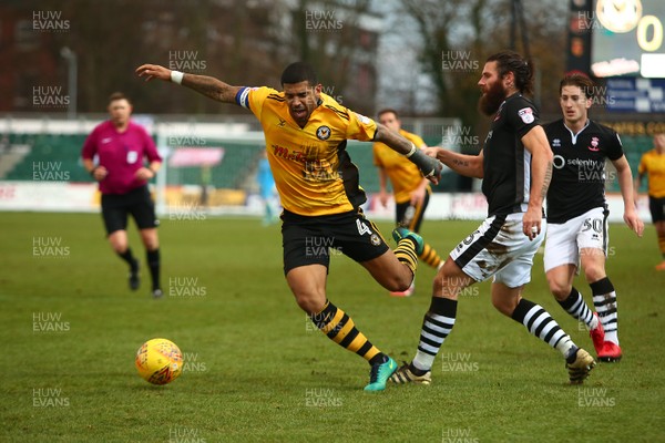 231217 - Newport County v Lincoln City - Sky Bet League 2 - Joss Labadie of Newport County is tackled by Michael Bostwick of Lincoln City 