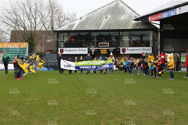 170318 - Newport County v Luton Town - Sky Bet League 2 - Children the Thrive Charity lead the teams out with the banner to promote The Disabled Supporters Association (DSA) celebrating Level Playing Fields (LPF) 2018 Weeks of Action campaign
