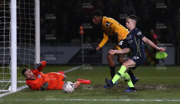 160219 - Newport County v Manchester City - FA Cup 5th Round - Tyreeq Bakinson of Newport County has his header saved by Keeper Ederson of Manchester City