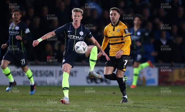 160219 - Newport County v Manchester City - FA Cup 5th Round - Oleksandr Zinchenko of Manchester City is challenged by Robbie Willmott of Newport County