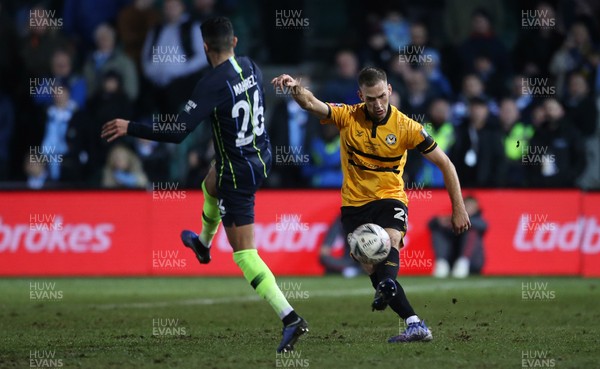 160219 - Newport County v Manchester City - FA Cup 5th Round - Mickey Demetriou of Newport County is challenged by Riyad Mahrez of Manchester City