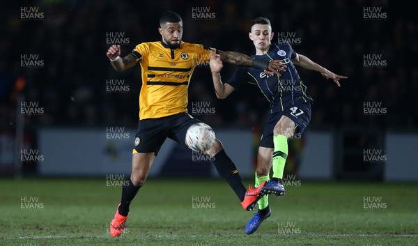160219 - Newport County v Manchester City - FA Cup 5th Round - Joss Labadie of Newport County is challenged by Phil Foden of Manchester City