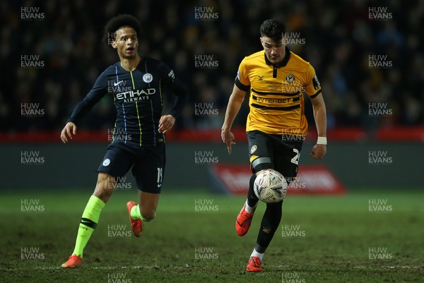 160219 - Newport County v Manchester City - FA Cup 5th Round - Regan Poole of Newport County is challenged by Leroy Sane of Manchester City