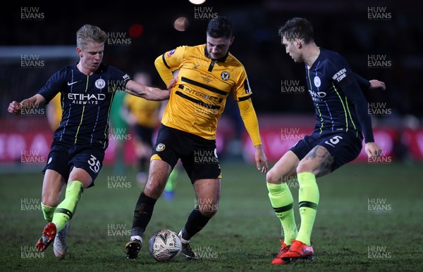 160219 - Newport County v Manchester City - FA Cup 5th Round - Padraig Amond of Newport County is challenged by Oleksandr Zinchenko of Manchester City