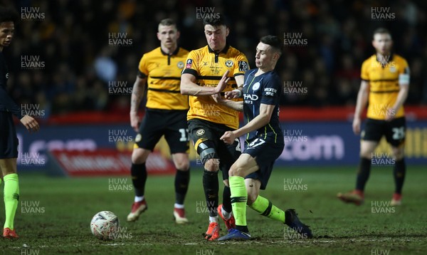 160219 - Newport County v Manchester City - FA Cup 5th Round - Regan Poole of Newport County is challenged by Phil Foden of Manchester City