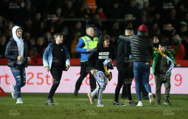 160219 - Newport County v Manchester City - FA Cup 5th Round - Fans run onto the pitch at full time