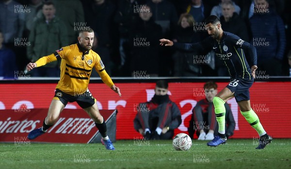 160219 - Newport County v Manchester City - FA Cup 5th Round - Riyad Mahrez of Manchester City is challenged by Dan Butler of Newport County