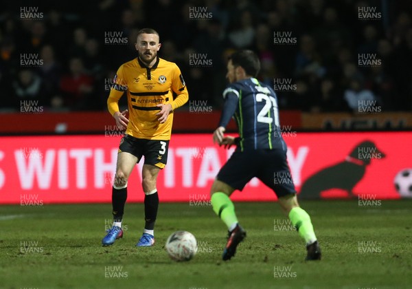 160219 - Newport County v Manchester City, FA Cup Fifth Round - Dan Butler of Newport County takes on David Silva of Manchester City