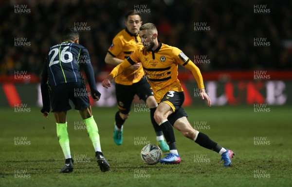160219 - Newport County v Manchester City, FA Cup Fifth Round - Dan Butler of Newport County takes on Riyad Mahrez of Manchester City