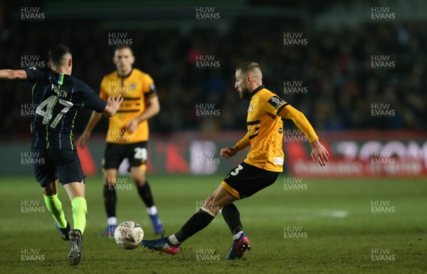 160219 - Newport County v Manchester City, FA Cup Fifth Round - Dan Butler of Newport County takes on Phil Foden of Manchester City