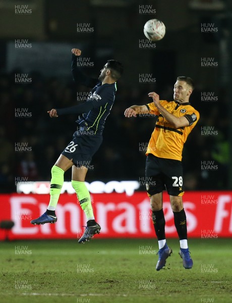 160219 - Newport County v Manchester City, FA Cup Fifth Round - Mickey Demetriou of Newport County and Riyad Mahrez of Manchester City compete for the ball