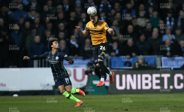 160219 - Newport County v Manchester City, FA Cup Fifth Round - Regan Poole of Newport County gets above Leroy Sane of Manchester City