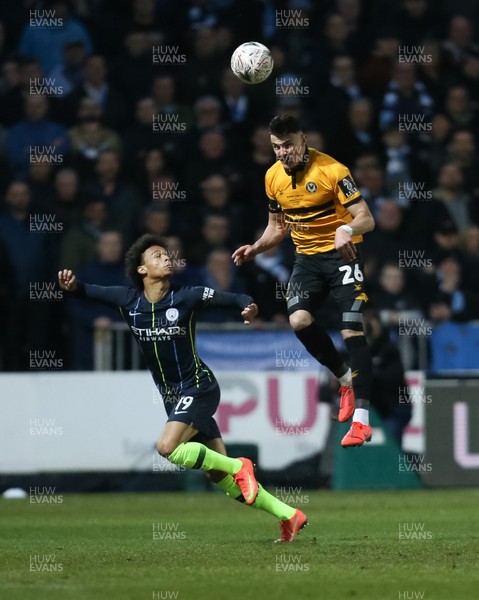 160219 - Newport County v Manchester City, FA Cup Fifth Round - Regan Poole of Newport County gets above Leroy Sane of Manchester City