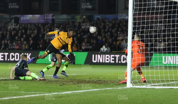 160219 - Newport County v Manchester City, FA Cup Fifth Round - Tyreeq Bakinson of Newport County goes close as he heads at Manchester City goalkeeper Ederson