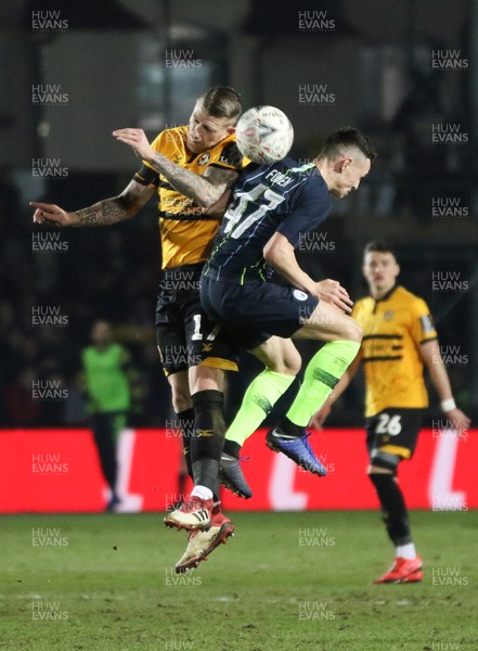 160219 - Newport County v Manchester City, FA Cup Fifth Round - Scot Bennett of Newport County and Phil Foden of Manchester City compete for the ball