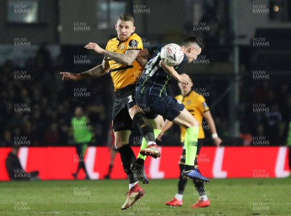 160219 - Newport County v Manchester City, FA Cup Fifth Round - Scot Bennett of Newport County and Phil Foden of Manchester City compete for the ball